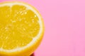 Image of cut half lemon on on a pink background. Minimal concept Royalty Free Stock Photo