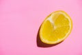 Image of cut half lemon on on a pink background. Minimal concept Royalty Free Stock Photo