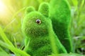 Image of cute furry squirrel toy over green lawn in the park