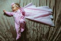 Image of cute little girl in pink suit and cloak