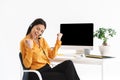 Image of cute phone operator woman wearing microphone headset sitting at her workplace in office