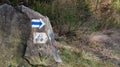 Image of a cyclist on a stone in a forest. A sign for cyclists to show the way. Log in for instructions. closeup of a cobblestone