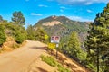 Dangerous dirt road path in mountains with warning signs proceed with caution