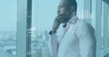 Image of data processing and diagrams over african american businessman thinking