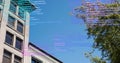 Image of data processing over building, tree and sky