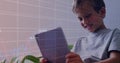 Image of data processing over caucasian boy using tablet Royalty Free Stock Photo