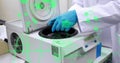 Image of data processing over mid section of a scientist using centrifuge machine at laboratory Royalty Free Stock Photo