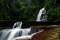 Deep tropical rain forest with flowing cascade waterfall Royalty Free Stock Photo