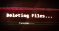 Image of deleting files processing text flashing digital interface
