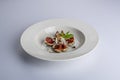 Image of delicious figs with coconut and mint on a white ceramic plate