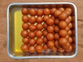 Image of delicious Indian sweets known as Gulab Jamun, decorated in aluminum trays
