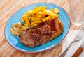 Image of a grilled beef steak and fried potatoes. Royalty Free Stock Photo