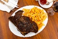 Image of a grilled beef steak and fried potatoes. Royalty Free Stock Photo