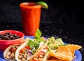 Image of a delicious red beverage with a taco plate