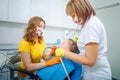 Image of dental checkup being given to little girl by dentist with assistant near by Royalty Free Stock Photo