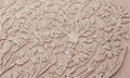 close-up view light pink fabric with floral pattern, featuring central flower surrounded by smaller leaves Royalty Free Stock Photo