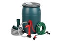 Garden watering system with drum and hose Royalty Free Stock Photo