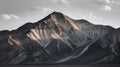 Sunlit Dramatic Mountain Peaks with Eroded Rock Patterns Against a Subtle Cloudy Sky Royalty Free Stock Photo