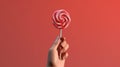 Hand holding lollipop on red background