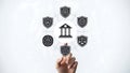 A hand touching a shield icon surrounded by various security and law symbols Royalty Free Stock Photo