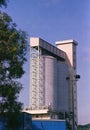 Industrial Grain Silos and Elevator Tower Against Clear Blue Sky Royalty Free Stock Photo
