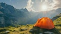 orange tent set up in a grassy area with a breathtaking mountain backdrop