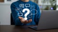 Person Holding Question Mark and Speech Bubbles Illustrating Customer Support and Online Communication Inquiry or Assistance Help Royalty Free Stock Photo