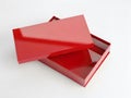 A red box with its lid partially open on a white background Royalty Free Stock Photo
