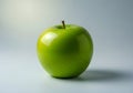A green apple sitting alone on a plain background looks fresh and inviting Royalty Free Stock Photo
