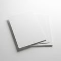 A stack of three blank white papers on a plain white surface. isolated on white background Royalty Free Stock Photo