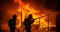 Firefighters battling a blazing structure fire Royalty Free Stock Photo