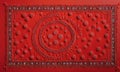 vibrant red textile features circular motif with crescent moon and small circles, surrounded by border small Royalty Free Stock Photo