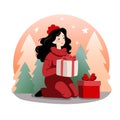 The image depicts a woman in a red sweater and hat sitting on the floor with two Christmas gifts in front of her. The gifts are Royalty Free Stock Photo