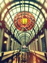 Depth perception photo of a modern hallway with a glass ceiling and red stained glass sculpture above