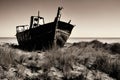 image of a deserted beach with an old boat, broken fence around the dunes and clusters of sea oats. Royalty Free Stock Photo