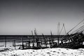 image of a deserted beach with an old boat broken fence around the dunes and clusters of sea oats.