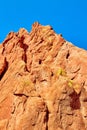 Detail of mountain red rock surface against blue sky