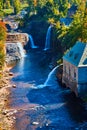 Detail of river canyon with multiple large waterfalls and Hydroelectric power plant