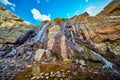 Detail of waterfall over mossy rocks in rocky mountains Royalty Free Stock Photo