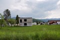 Image of devastated unfinished house structure in rural village area