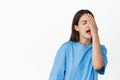 Image of devestated brunette girl slap face, facepalm frustrated, failure emotion, standing over white background