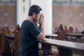 Devout man praying in the church Royalty Free Stock Photo