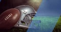 Image of diagonal blue stripe moving over american football and helmet, on grass pitch Royalty Free Stock Photo