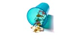 Image of different pills spilling out of a plastic glass Royalty Free Stock Photo