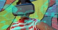 Image of digital interface, data and brain over young child using VR headset and pointing Royalty Free Stock Photo