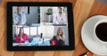 Image of digital interface with icons on digital tablet screen with people talking on video call Royalty Free Stock Photo