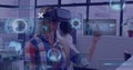 Image of digital screens and data processing over caucasian woman using vr headset