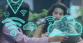 Image of digital wifi and cloud icons over diverse business people in office Royalty Free Stock Photo