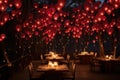 An image of a dining area with tables, decorated with red balloons hanging from the ceiling, A romantic evening dinner underneath Royalty Free Stock Photo