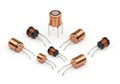 Assorted copper-coated electronic inductors and coils on a white background Royalty Free Stock Photo